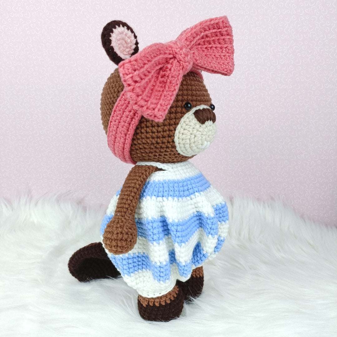 Cute crocheted beaver in baggy romper and big ribbon head band.