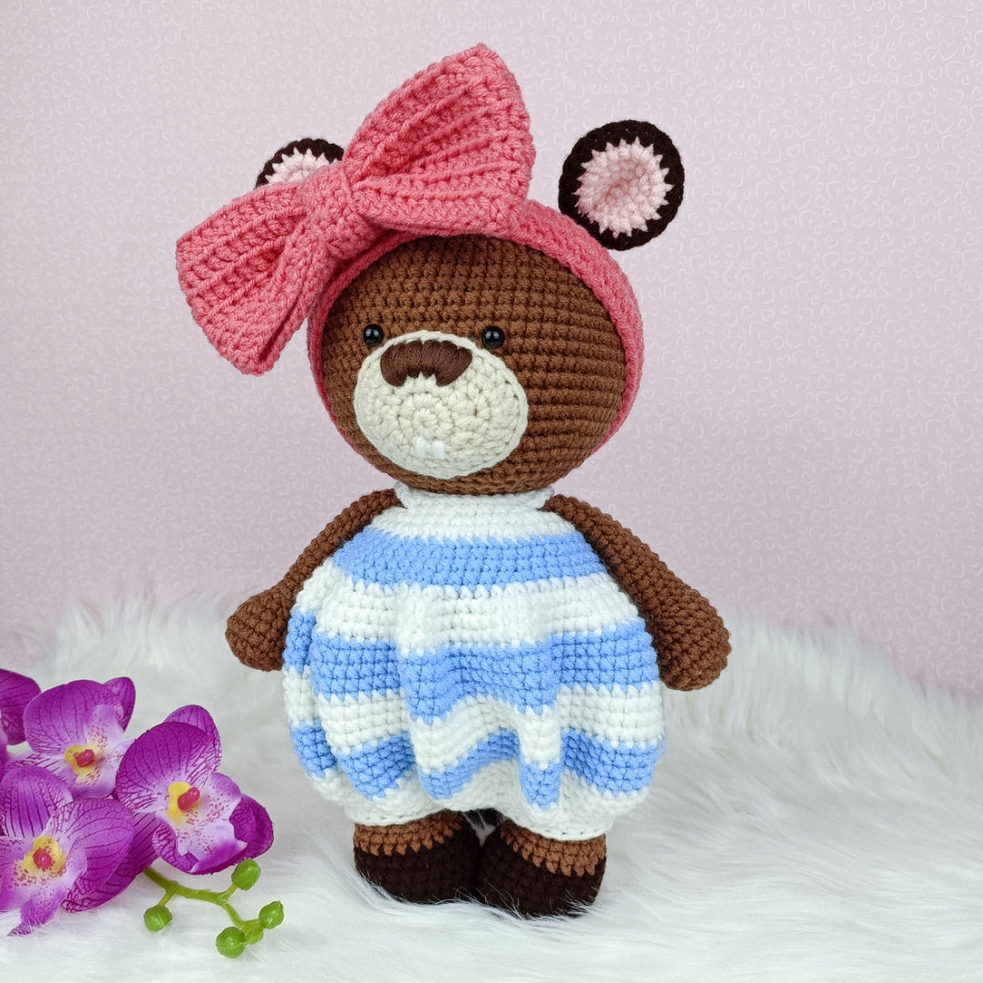 Cute crocheted beaver in baggy romper and big ribbon head band.