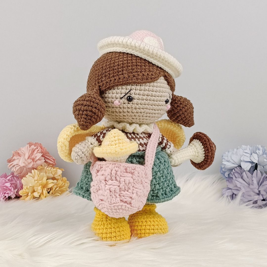 Cute crochet doll holding mushroom