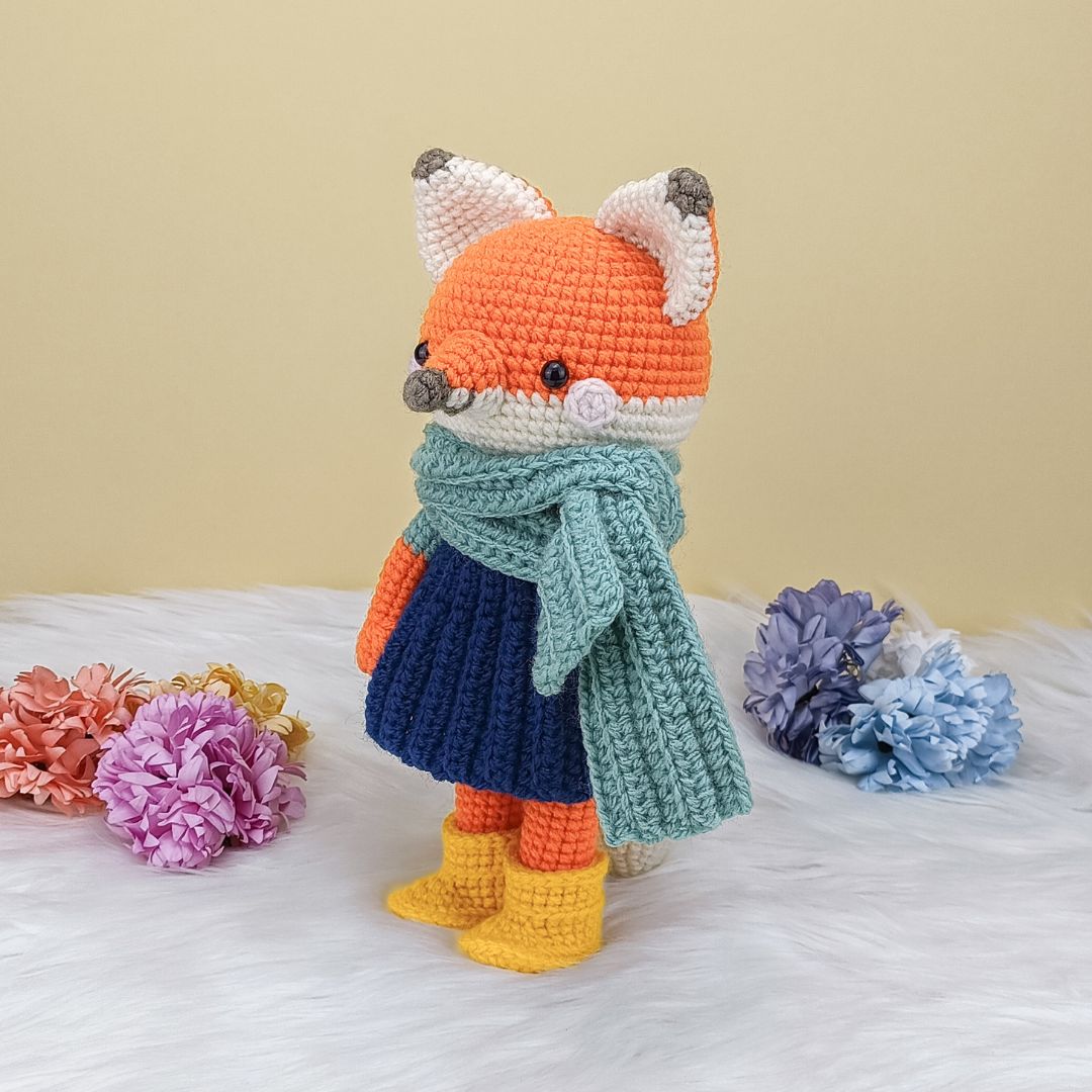 Soft toy fox in green scarf