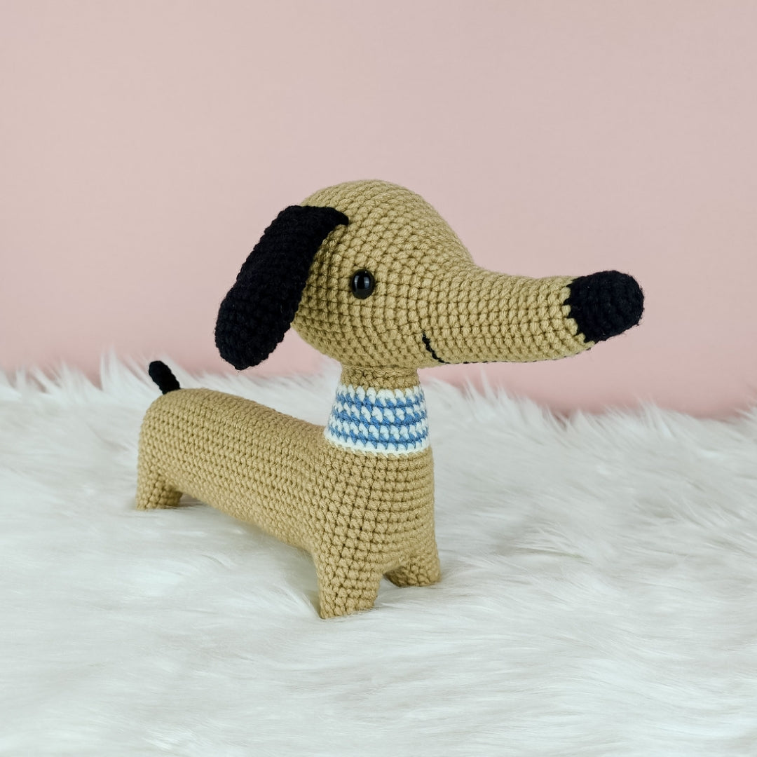 Smiling amigurumi dachshund dog