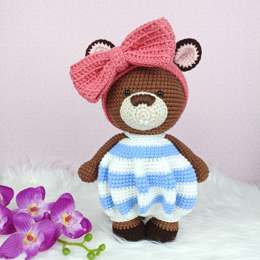 Cute crocheted beaver in baggy romper and big ribbon head band. 