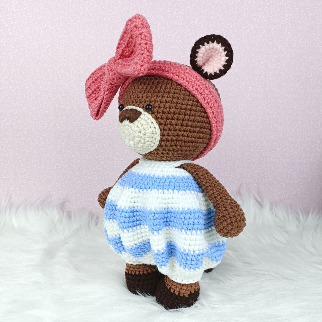 Cute crocheted beaver in baggy romper and big ribbon head band. 