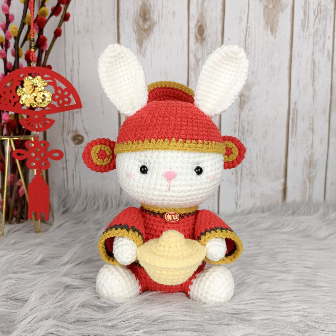 Crochet fortune bunny holding gold ingot