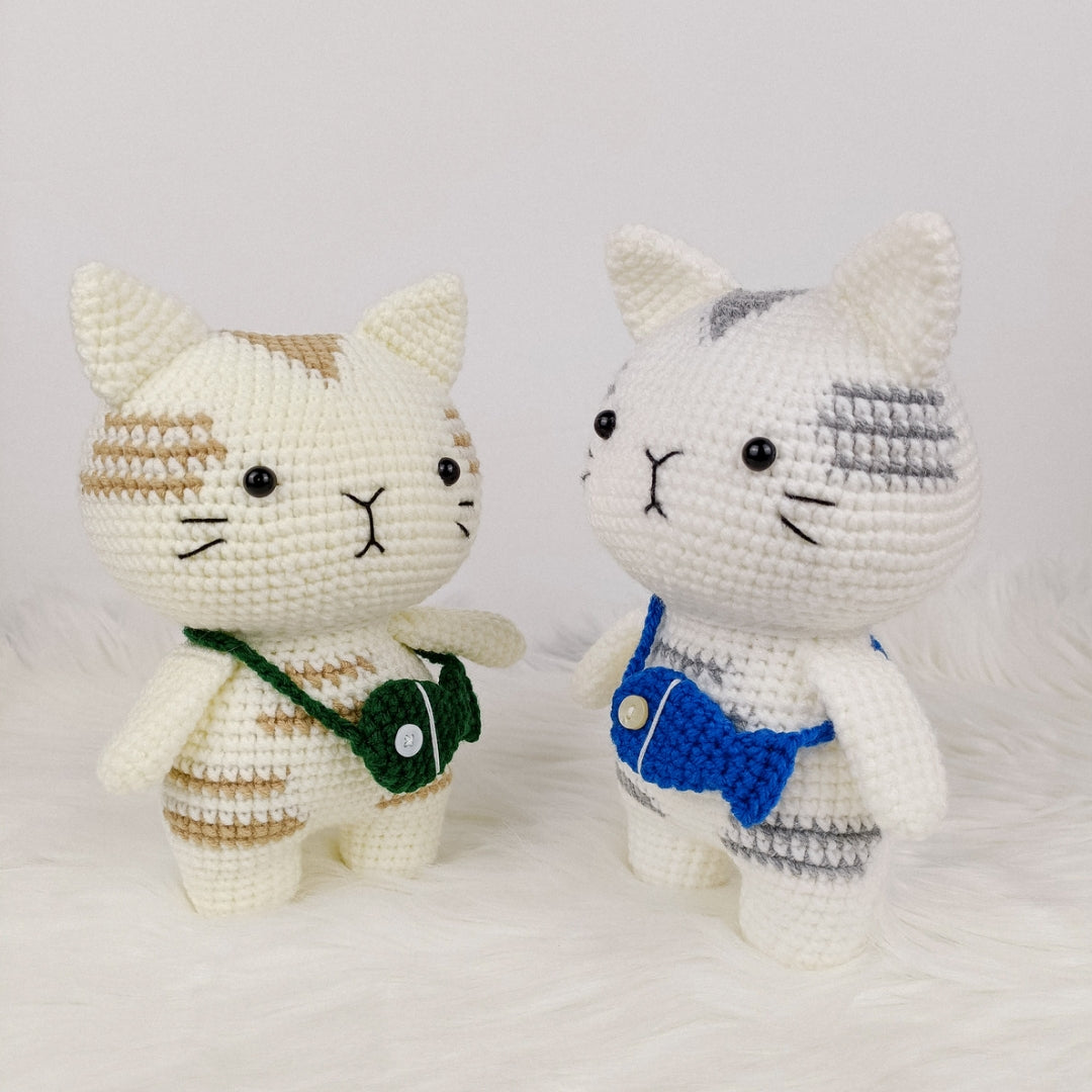 Adorable crocheted cat who loves his fish pouch.
