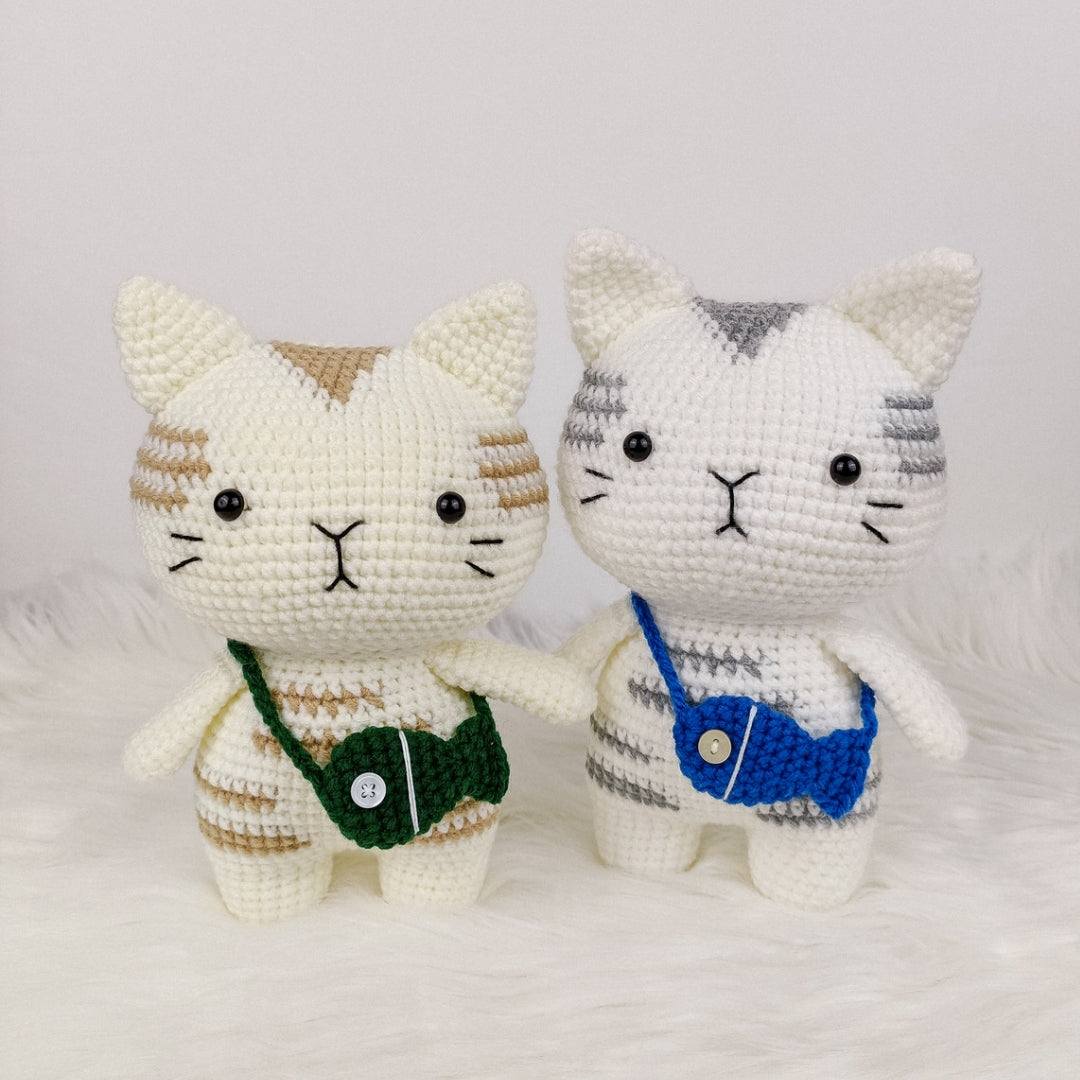 Adorable crocheted cat who loves his fish pouch.