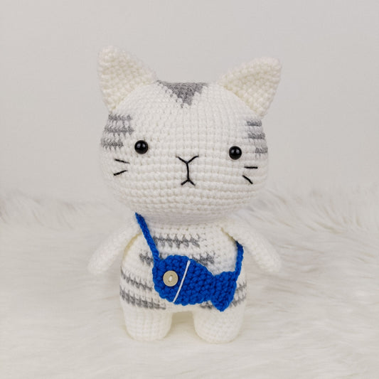Adorable crocheted cat who loves his fish pouch.