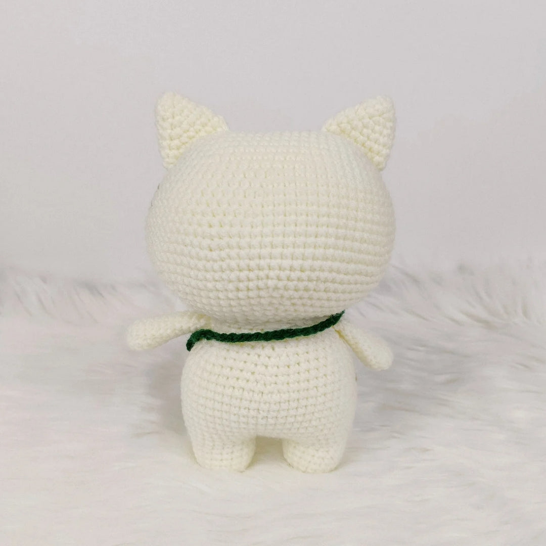 Adorable crocheted cat who loves his fish pouch.