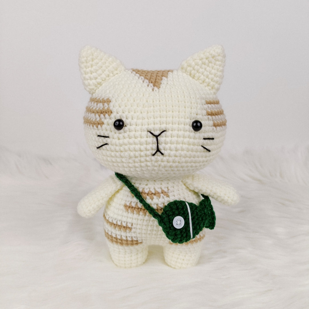 Adorable crocheted cat who loves his fish pouch.